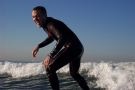 Student standing up on surfboard