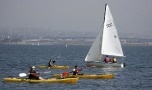 Kayaks beside sailboat in Crown Cove